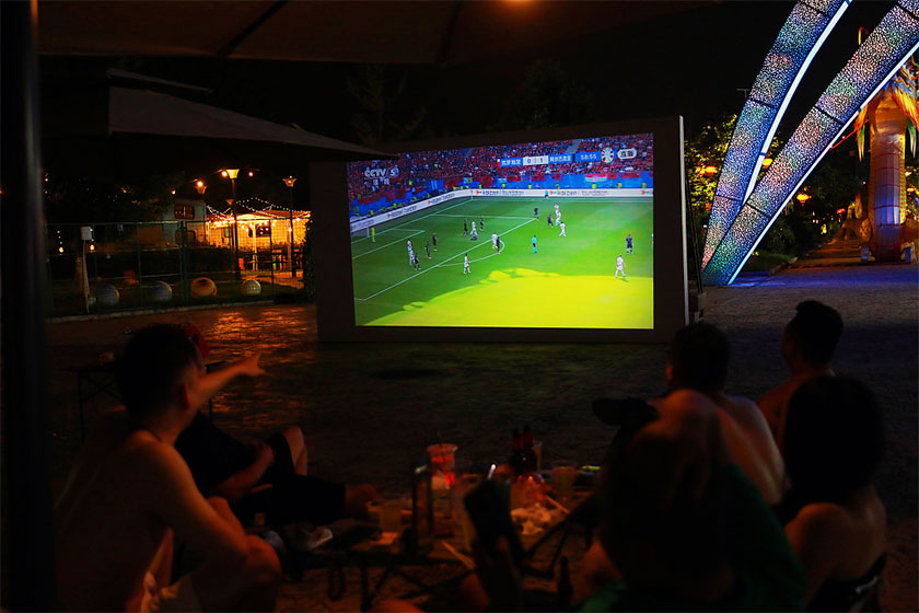 Residents watch a Euro 2024 game at a night market in Yichang, Hubei province, on June 19, 2024